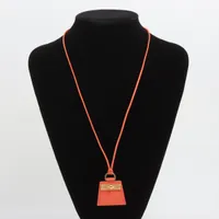 エルメス モンプティケリー ネックレス レザー×GP オレンジ